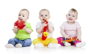 Children playing with musical toys on white background